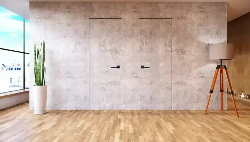 Minimalistyczna ściana z płyty meblowej z dwiema ukrytymi drzwiami, ozdobiona betonową fakturą.